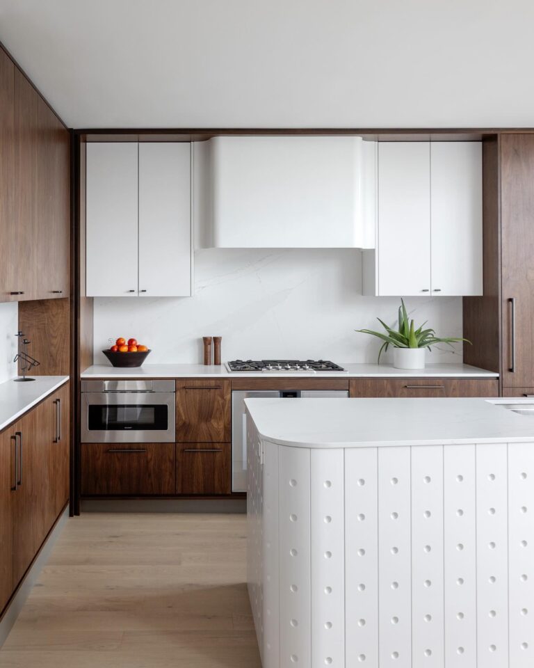 Upper cabinets curved into the hood: a kitchen made for one client.