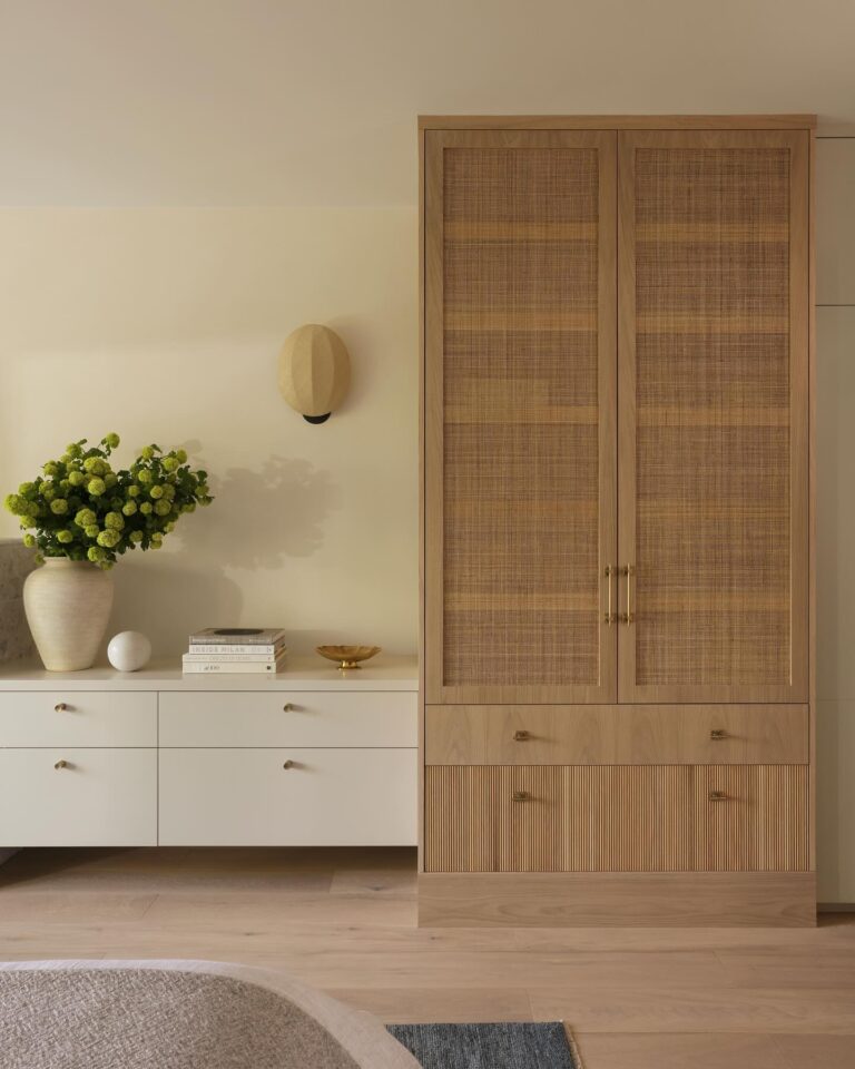 A primary bedroom in layered neutrals, steps from the beach.