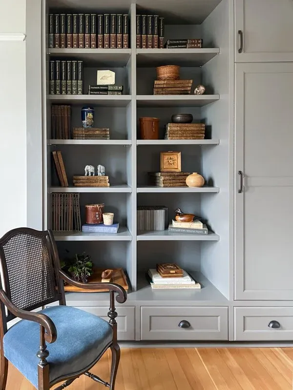 Heritage Home Restoration — built-in shelving and blue chair
